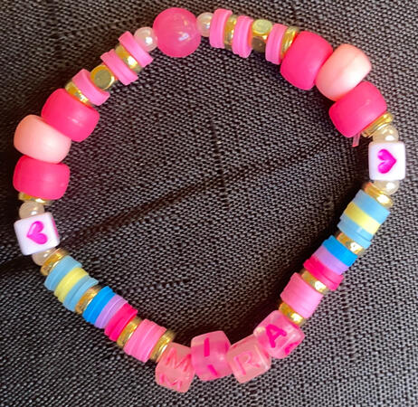 Mira bracelet Bracelet in gold and pink, inspired by Mira from K-Pop Demon Hunters. There is also two sections that match with the other Huntr/x members, one in yellow and blue, the other in blue, purple and pink.