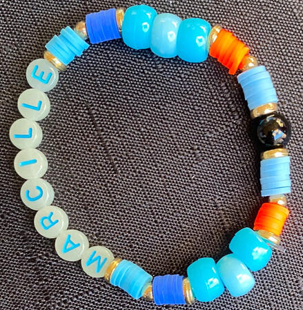 Bracelet in red, black, gold and varying shades of blue, inspired by Falin from Delicious in Dungeon.