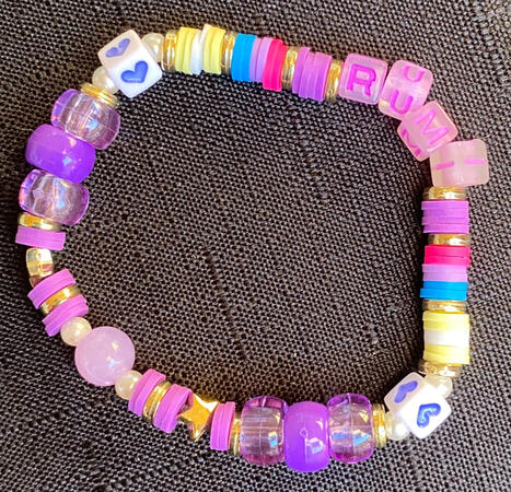 Bracelet in gold and purple, inspired by Rumi from K-Pop Demon Hunters. There is also two sections that match with the other Huntr/x members, one in yellow and white, the other in blue, purple and pink.
